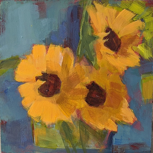 three sunflowers with light green and stubby vase on aqua background