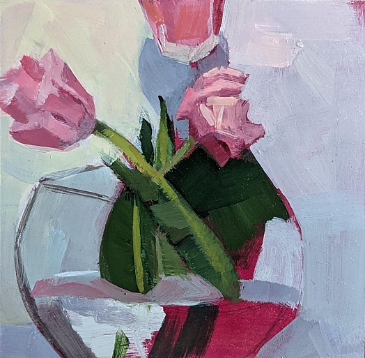 three pink tulips in glass vase