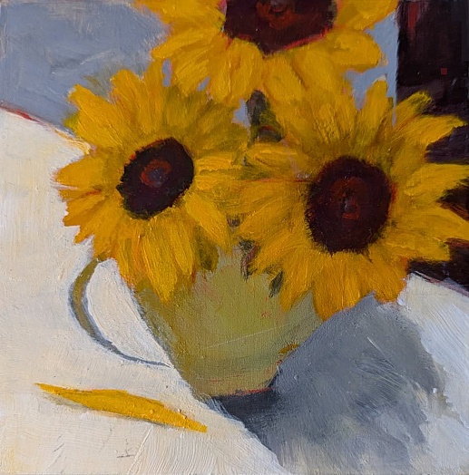 sunflowers in pale green vase on white table